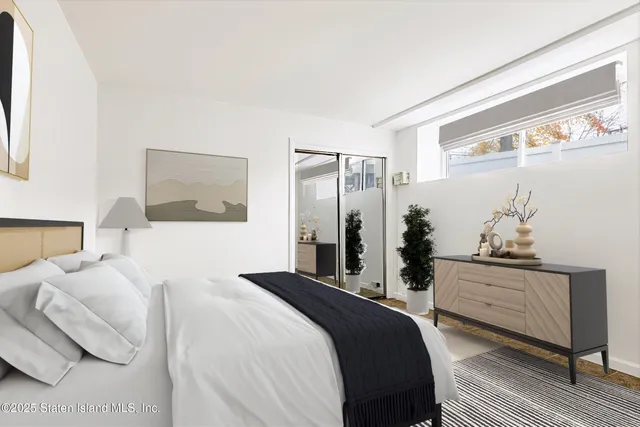 a bedroom with a bed and a dresser