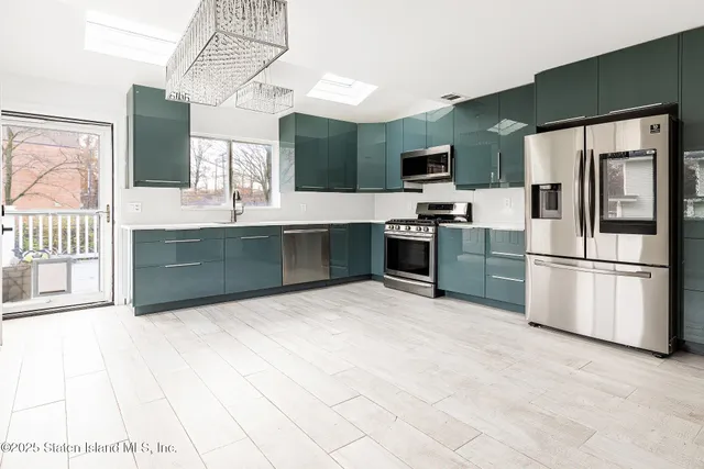 a kitchen with stainless steel appliances granite countertop a refrigerator and a stove top oven