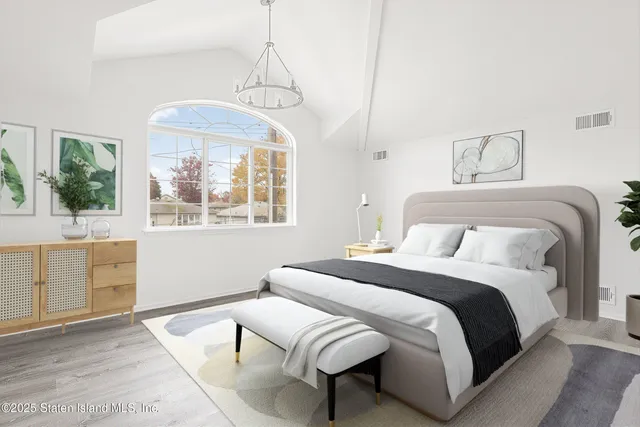 a spacious bedroom with a bed and window