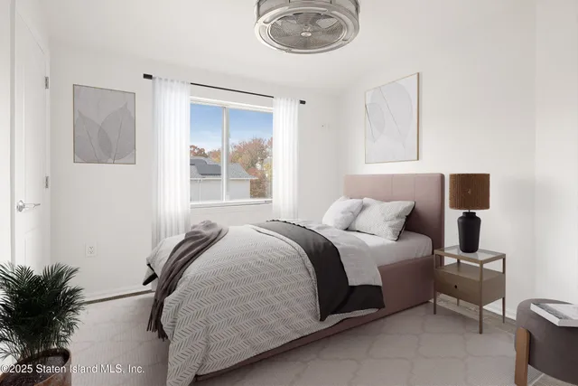 a spacious bedroom with a bed and a potted plant