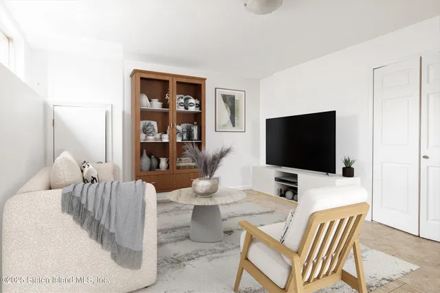 a hotel room with chairs and a flat screen tv