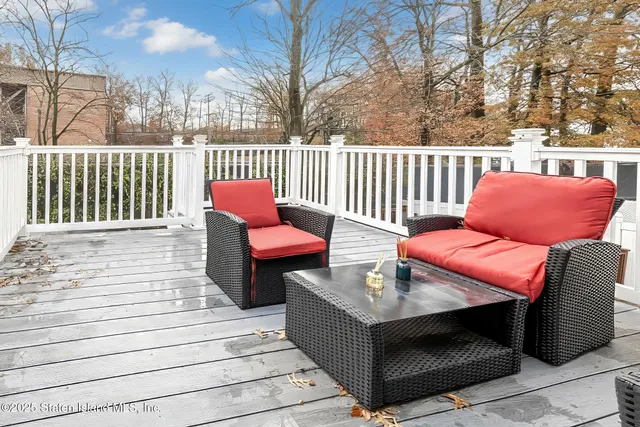 a outdoor sitting area with furniture and wooden floor