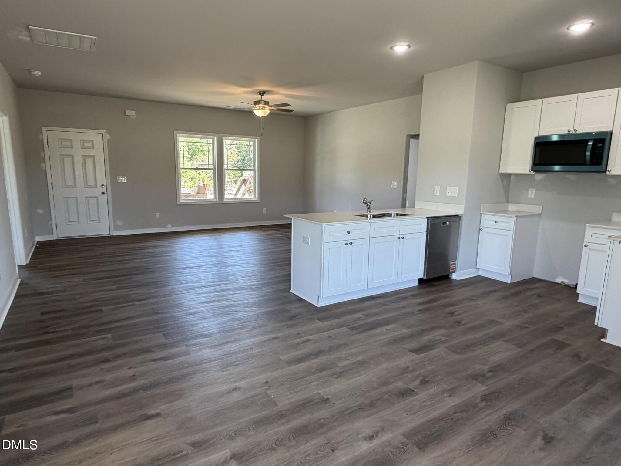 25 Jacobs Ridge Drive Four Oaks, NC 27524 - Photo 6 of 18 a large kitchen with wooden floors and stainless steel appliances