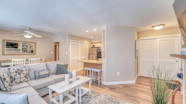 a kitchen with stainless steel appliances kitchen island granite countertop a refrigerator and wooden cabinets