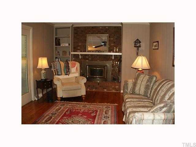 1413 Falls Church Road Raleigh, NC 27609 - Photo 4 of 12 a living room with furniture and a fireplace