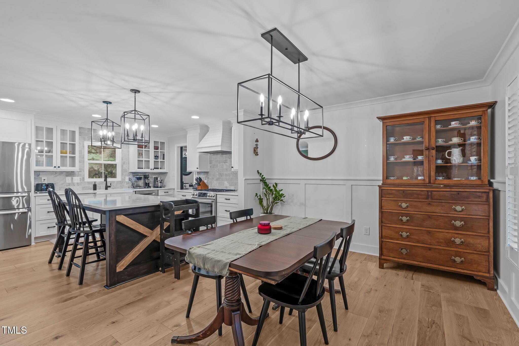 8505 Stonegate Drive Raleigh, NC 27615 - Photo 13 of 32 a view of a dining room with furniture wooden floor and chandelier