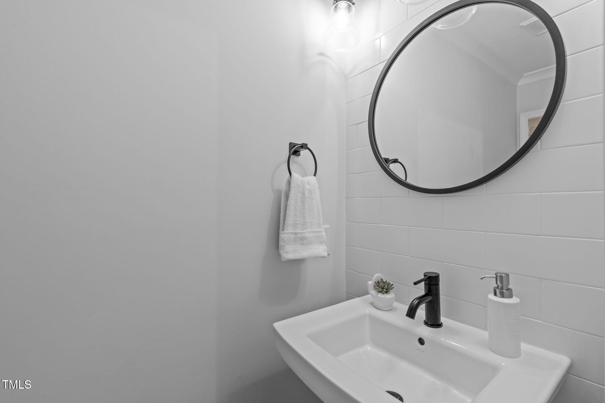 8505 Stonegate Drive Raleigh, NC 27615 - Photo 15 of 32 a bathroom with a sink and a mirror