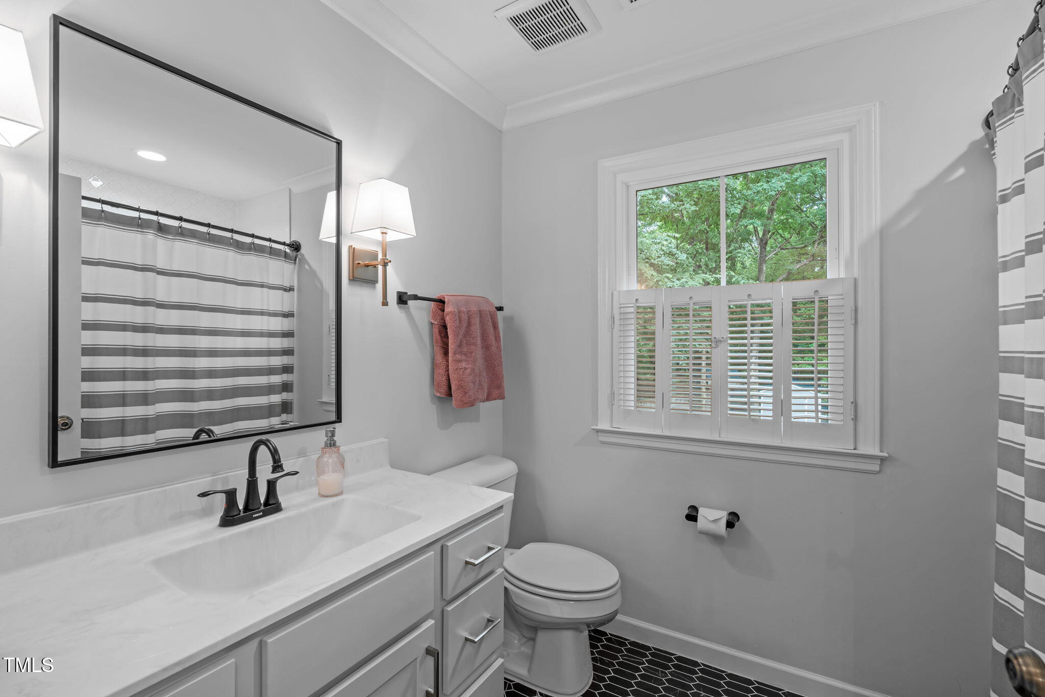 8505 Stonegate Drive Raleigh, NC 27615 - Photo 17 of 32 a bathroom with a sink toilet and a mirror