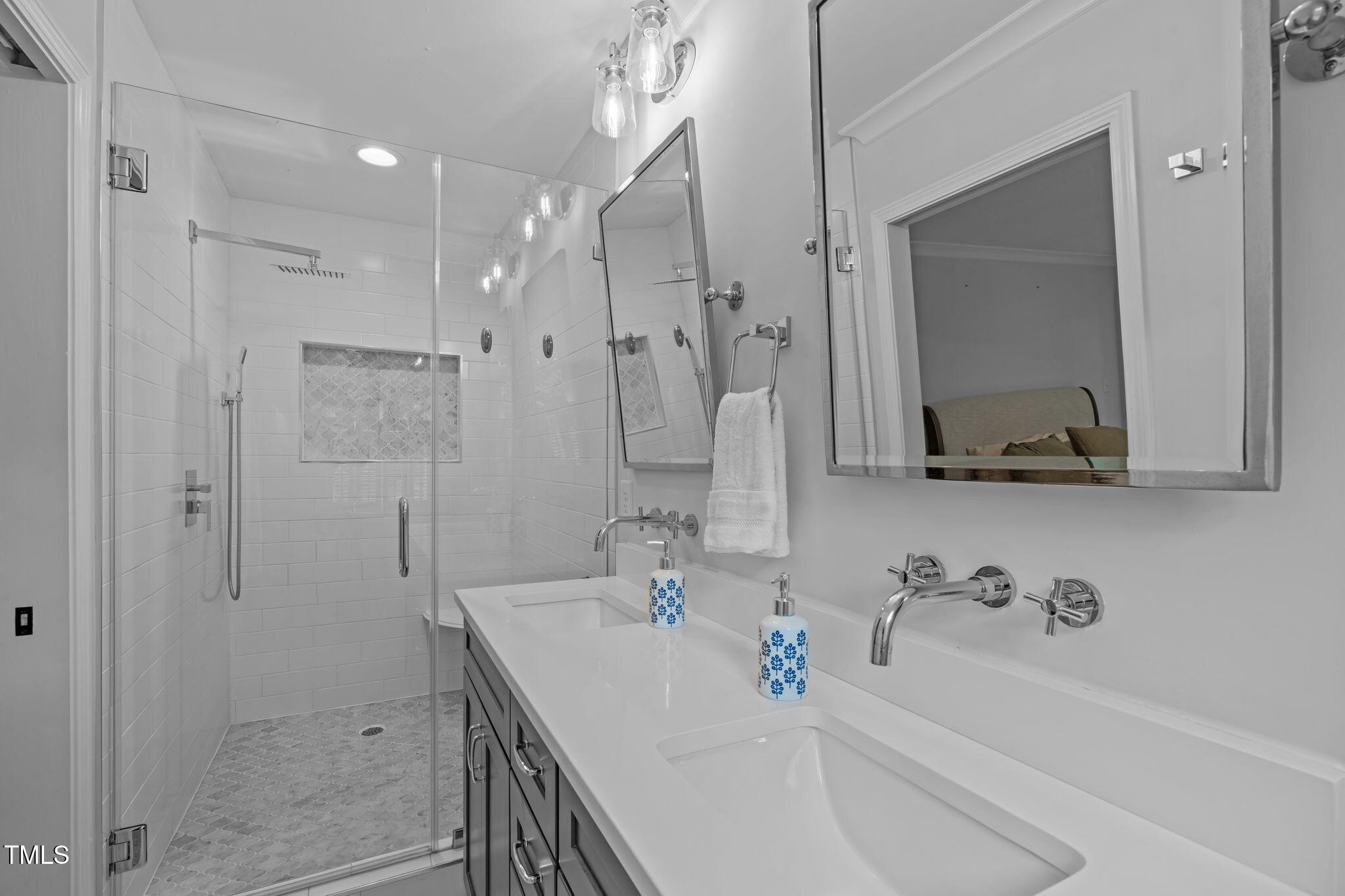 8505 Stonegate Drive Raleigh, NC 27615 - Photo 24 of 32 a bathroom with a tub sink a mirror and shower