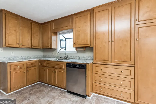 a kitchen with granite countertop cabinets and window