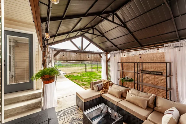 a balcony with furniture and a potted plant