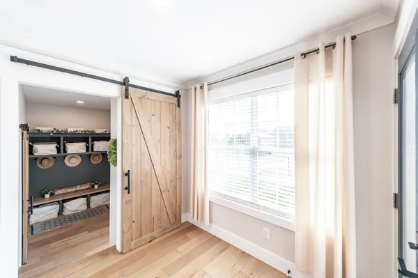 a view of entryway with wooden floor and door