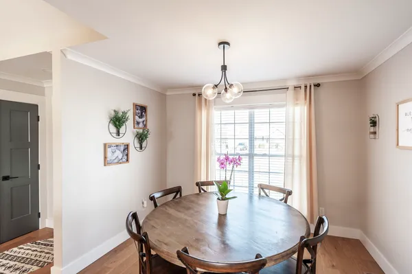 a view of a dining room with furniture window and wooden floor