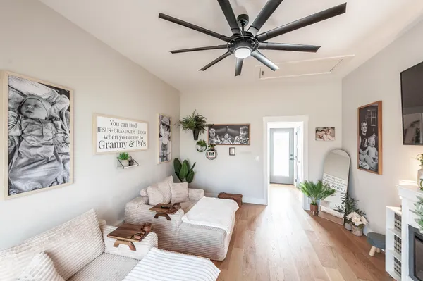 a living room with furniture and a wooden floor