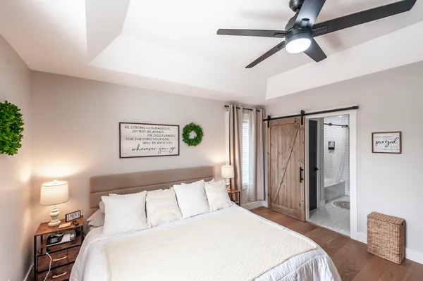 a bedroom with a bed and a lamp