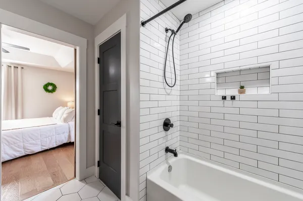 a bathroom that has a tub and a shower