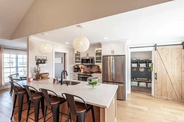 a view of a dining room with furniture and a chandelier