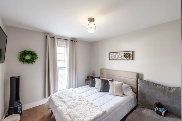 a bedroom with a bed and a window