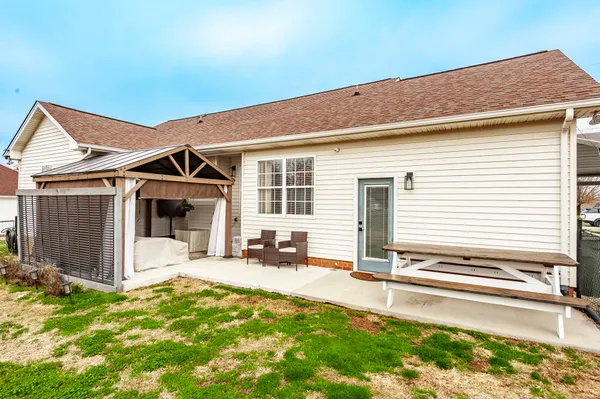 a backyard of a house with yard and seating space