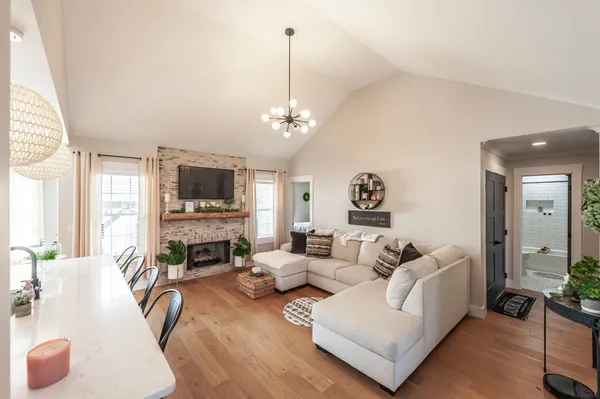 a living room with furniture flat screen tv and a fireplace