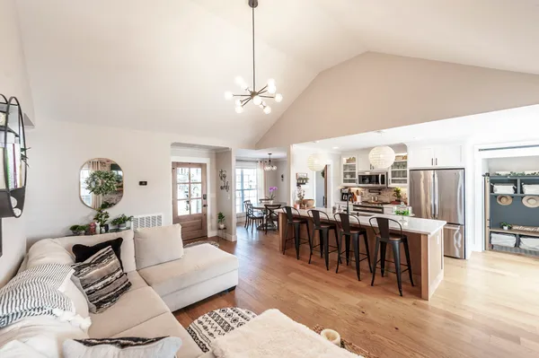 a living room with lots of furniture and kitchen view