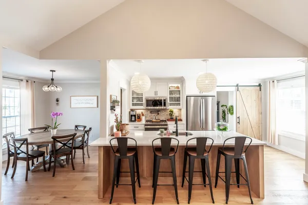 a view of a dining room with furniture and wooden floor