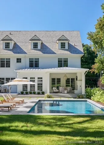 a front view of a house with a yard table and chairs