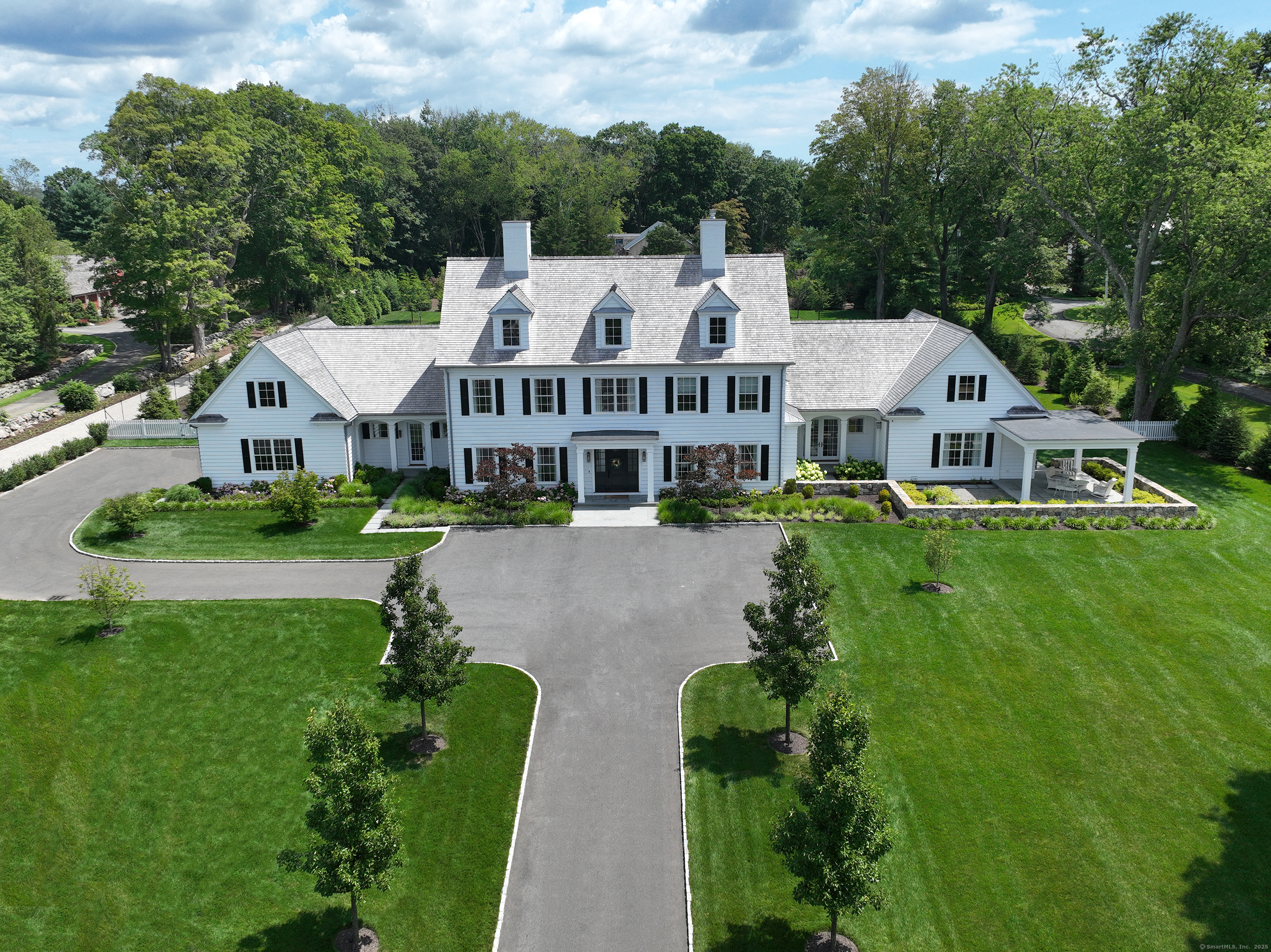 688 Hulls Farm Road Fairfield, CT 06890 - Photo 14 of 18 a view of house with garden and tall trees