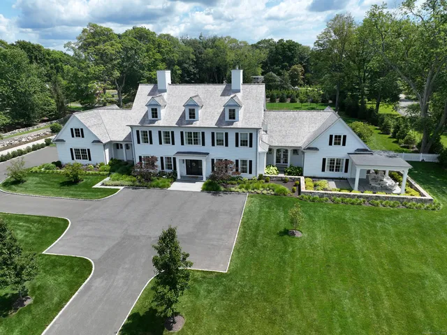 a aerial view of residential houses with yard and green space