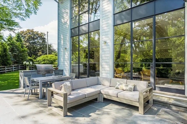 a living room with furniture and a floor to ceiling window