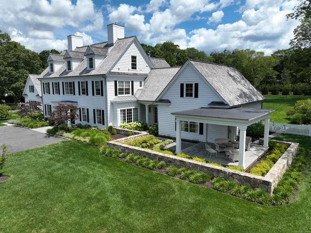 a front view of a house with a yard table and chairs