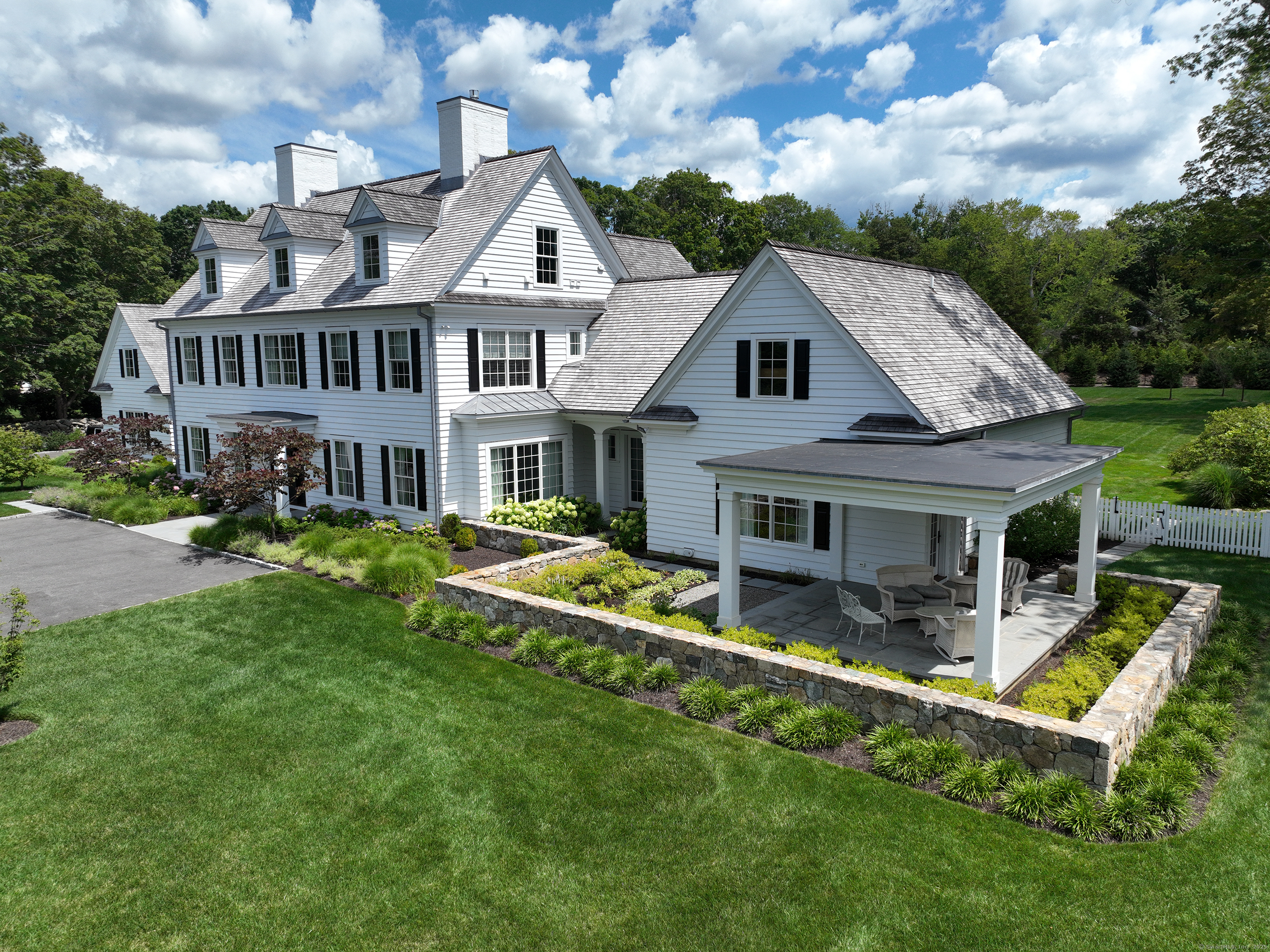 688 Hulls Farm Road Fairfield, CT 06890 - Photo 18 of 18 a front view of a house with a yard table and chairs