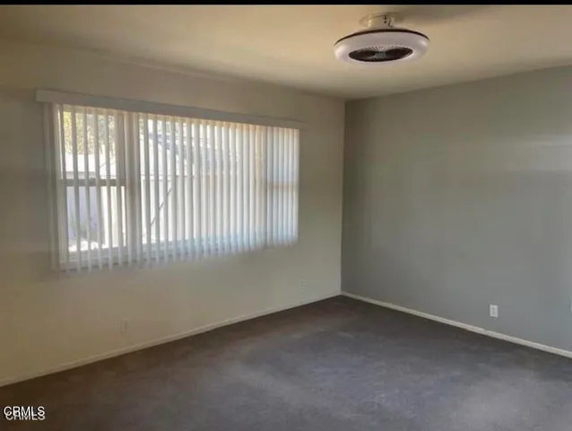 an empty room with a empty space and windows