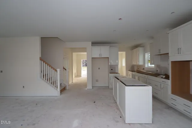a kitchen with stainless steel appliances a refrigerator and cabinets