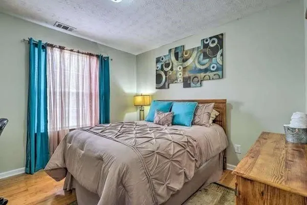 a bedroom with a bed and a window