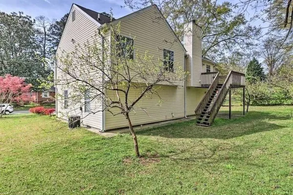 a view of a backyard with a tree