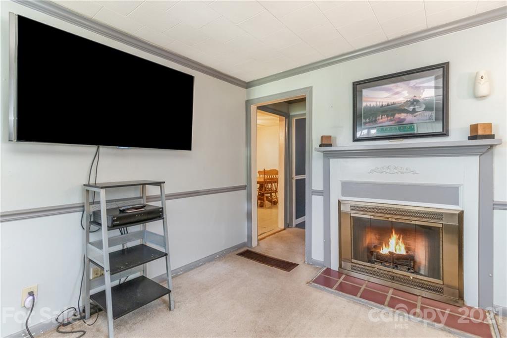 507 State Rd S-29-70 Lancaster, SC 29720 - Photo 2 of 27 a living room with furniture a flat screen tv and a fireplace