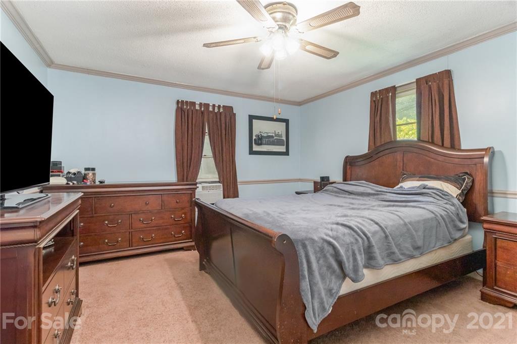 507 State Rd S-29-70 Lancaster, SC 29720 - Photo 11 of 27 a bedroom with a bed and a flat screen tv
