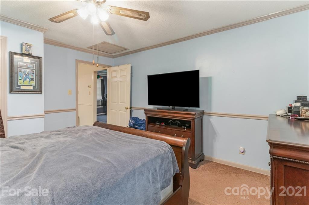 507 State Rd S-29-70 Lancaster, SC 29720 - Photo 13 of 27 a bedroom with a bed and a flat screen tv