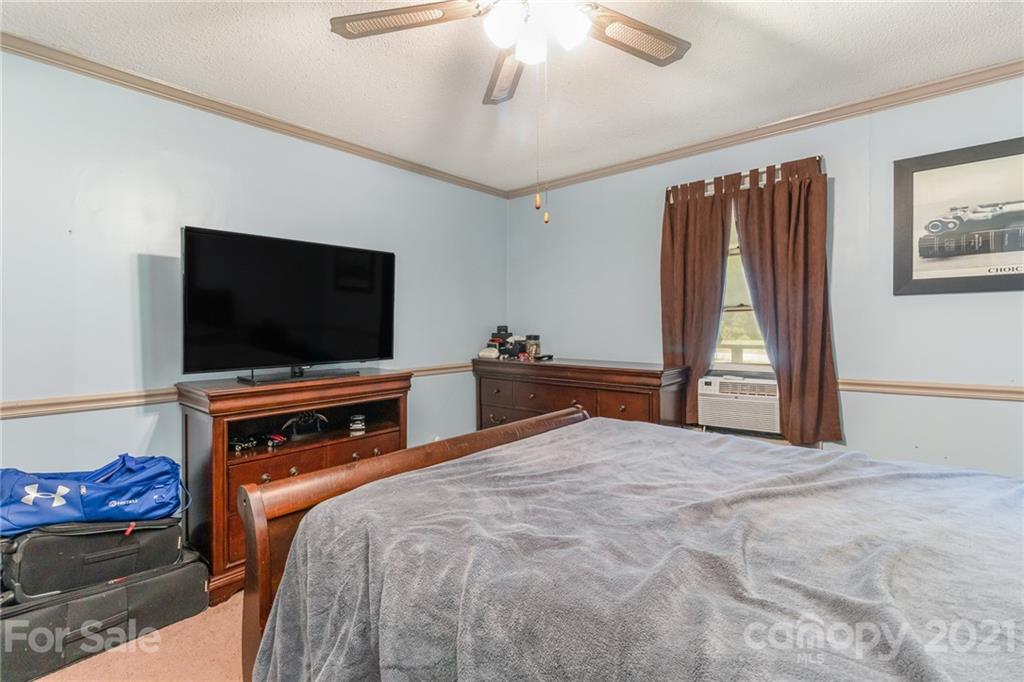 507 State Rd S-29-70 Lancaster, SC 29720 - Photo 14 of 27 a bedroom with a bed and a flat screen tv