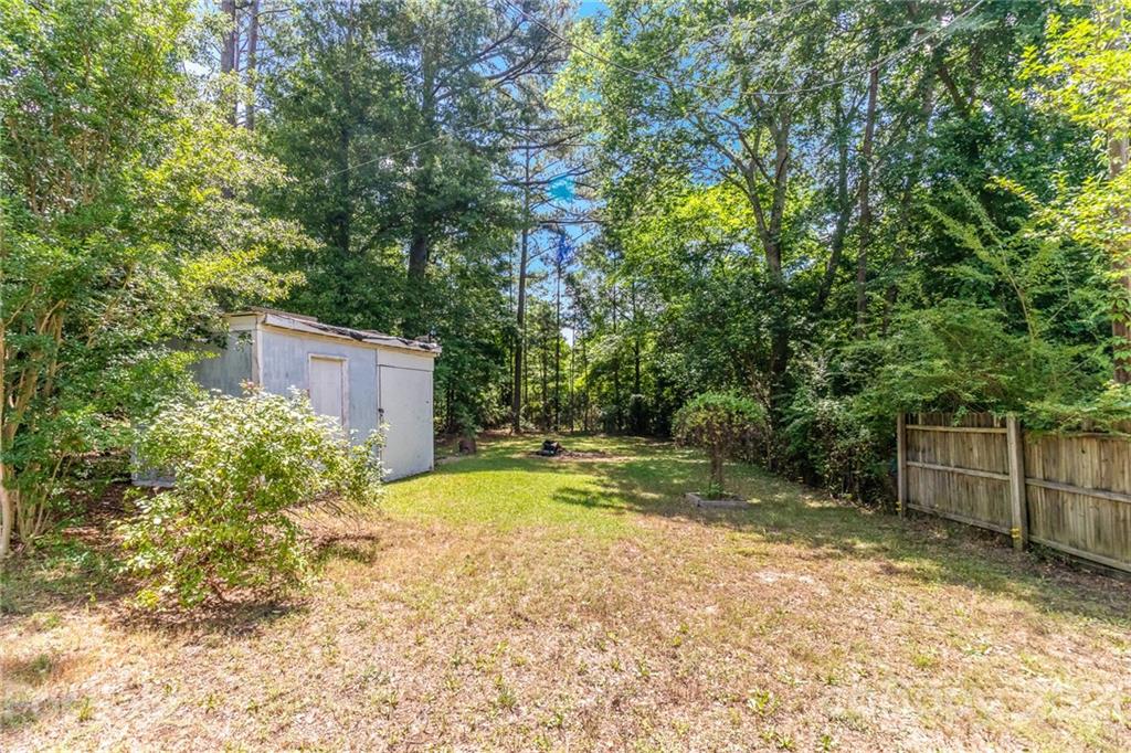 507 State Rd S-29-70 Lancaster, SC 29720 - Photo 22 of 27 a view of a backyard with large trees and plants