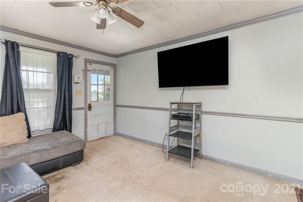 507 State Rd S-29-70 Lancaster, SC 29720 - Photo 5 of 27 a living room with a flat screen tv and a ceiling fan