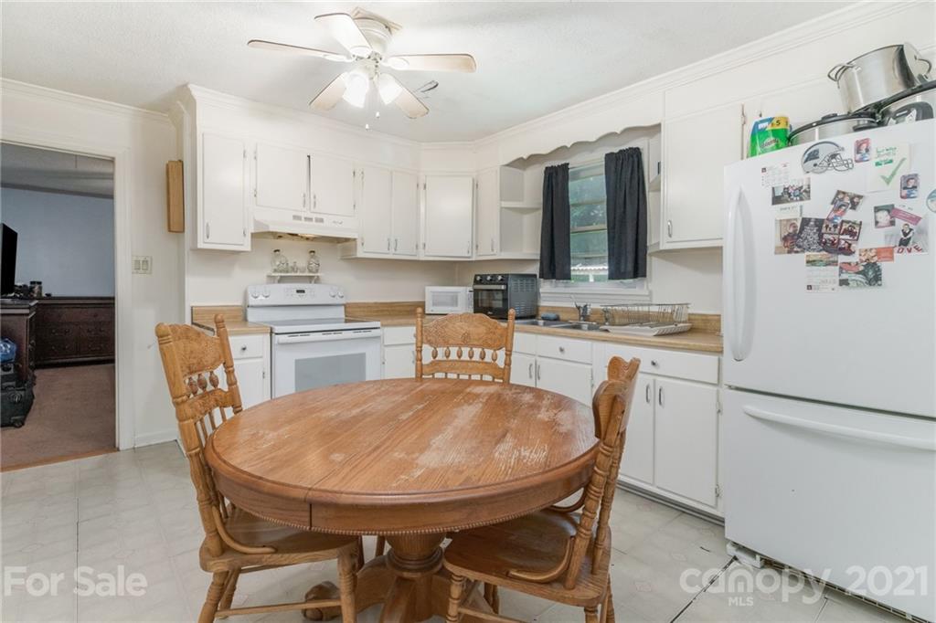507 State Rd S-29-70 Lancaster, SC 29720 - Photo 10 of 27 a dining table chairs and a refrigerator in a kitchen