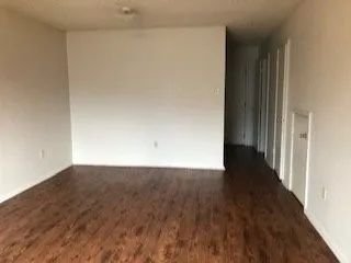 a view of an empty room and wooden floor