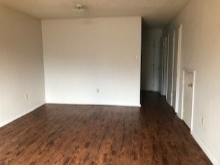 16161 Tiger Bend Road Baton Rouge, LA 70817 - Photo 13 of 17 a view of an empty room and wooden floor