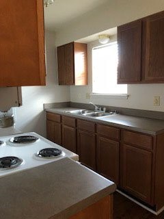 16161 Tiger Bend Road Baton Rouge, LA 70817 - Photo 17 of 17 a kitchen with a sink a stove and cabinets
