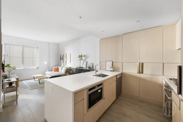 a view of a kitchen with furniture and wooden floor