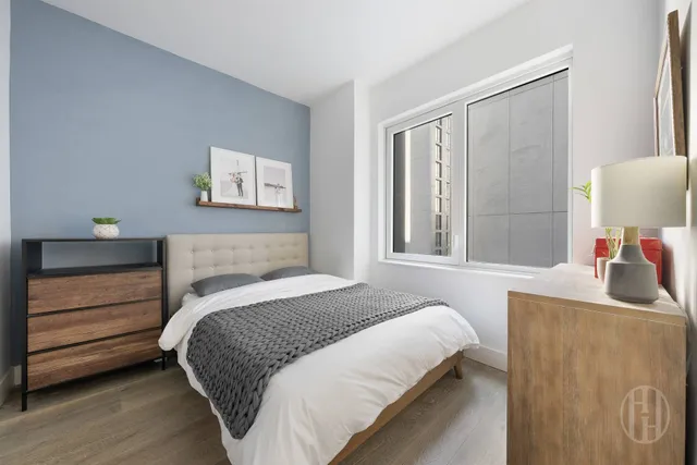 a bedroom with a bed and a desk