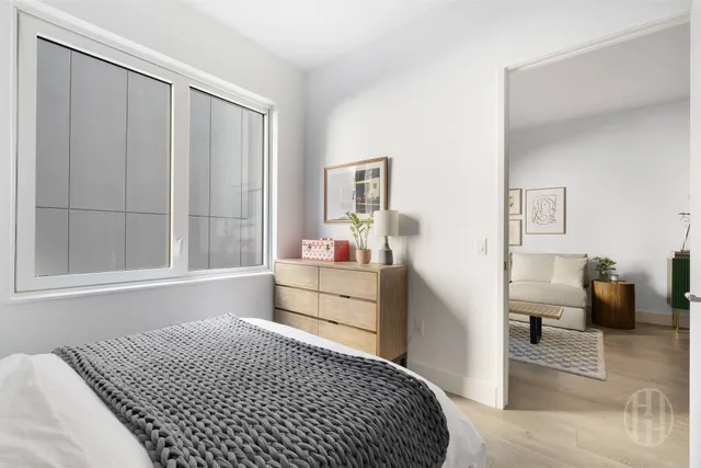 a bedroom with a bed and a dresser