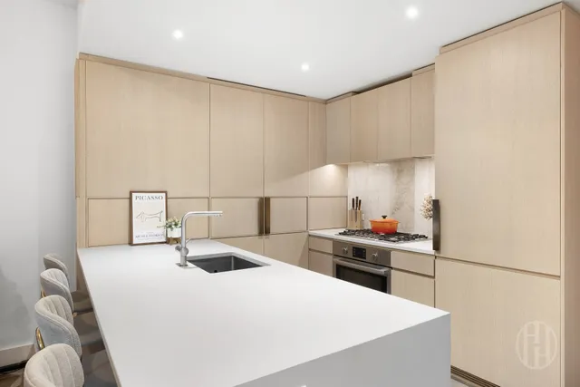 a kitchen with a dining table chairs refrigerator and cabinets